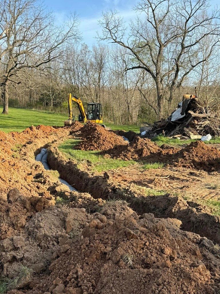 Excavator clearing and demolishing on a job site