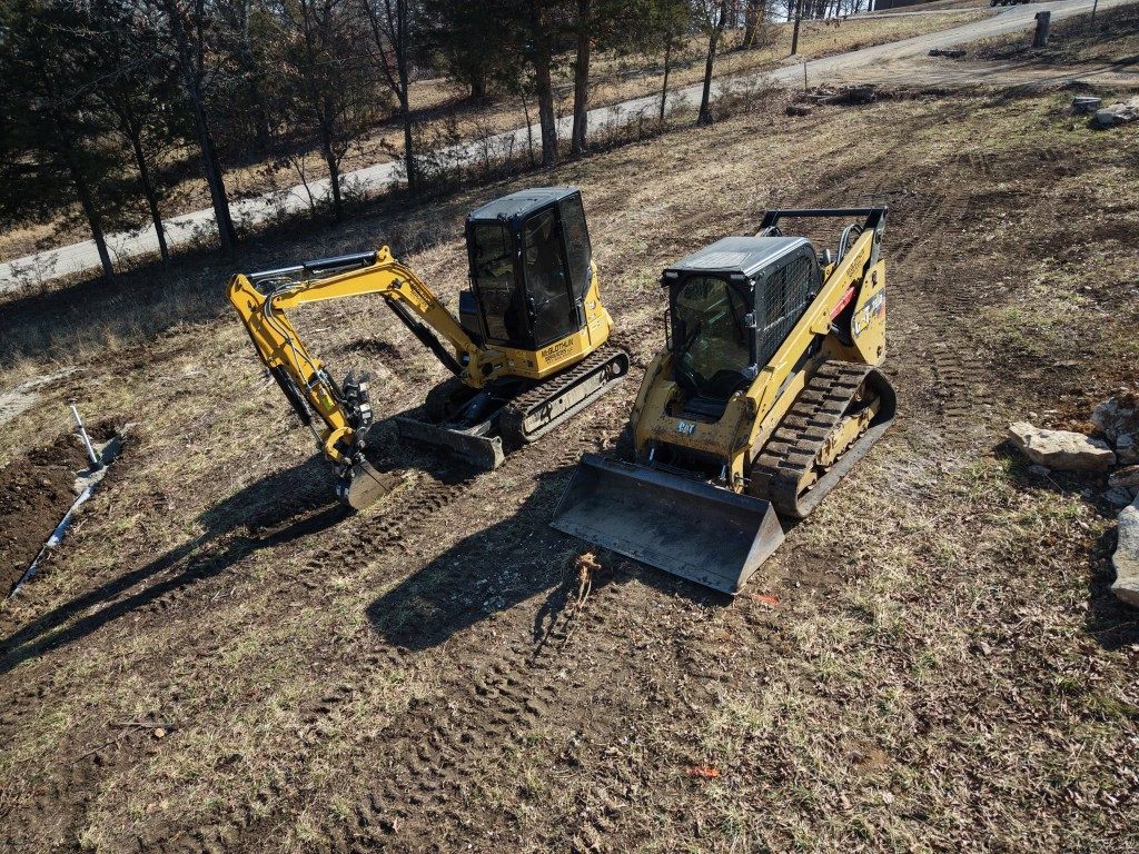 Aerial view of site work with an excavator and skid steer